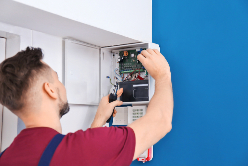 Electrician Installing Alarm System - finding emergency electricians