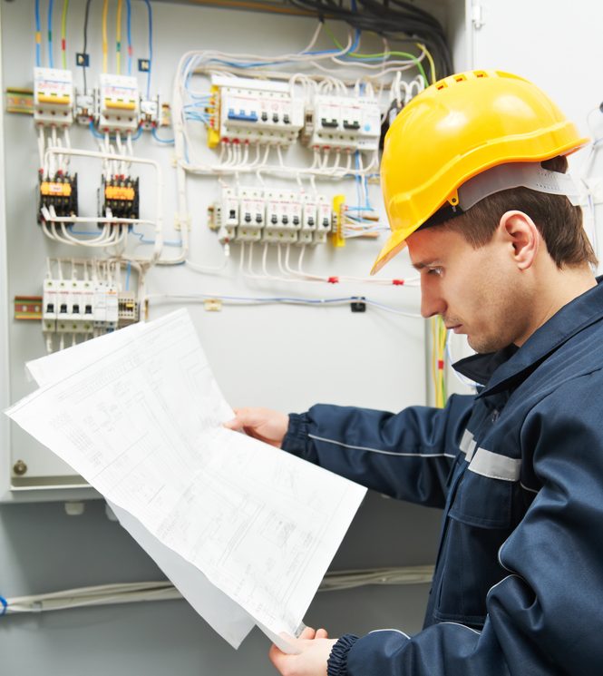 Electrician Builder At Work Inspecting Cabling Connection Of High Voltage