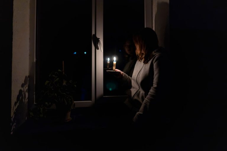 Woman Holding a Candle During a Power Outage