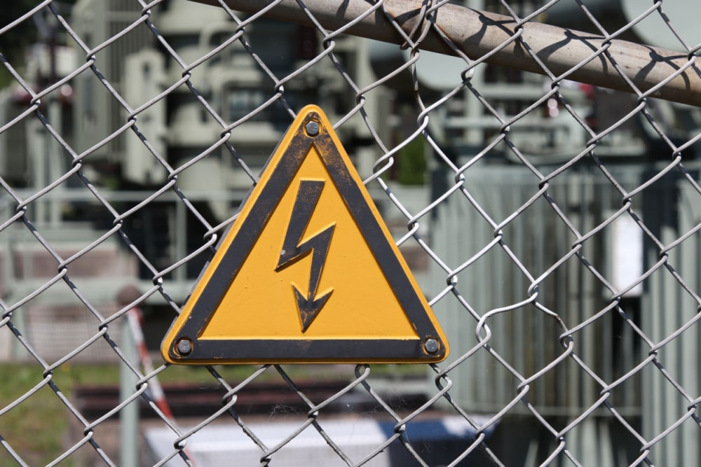 yellow hazard power surge caution sign